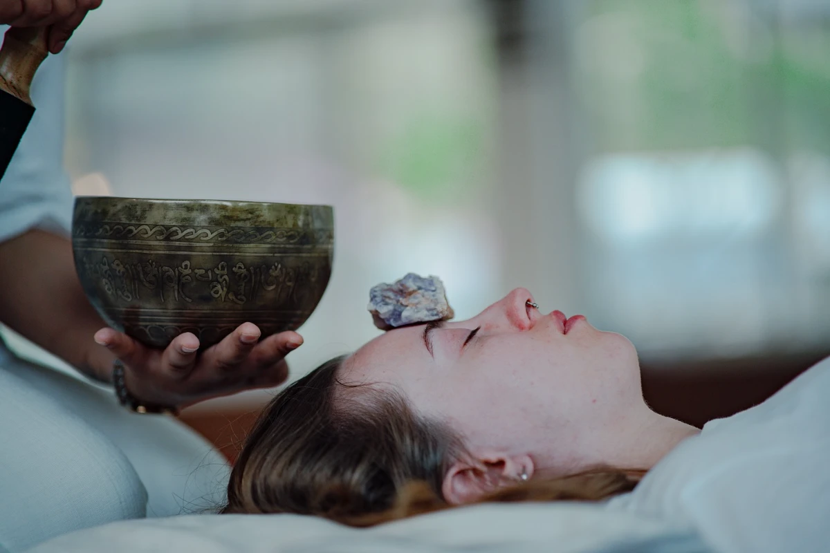 Group sound bath session with gongs and singing bowls at Adhiroha