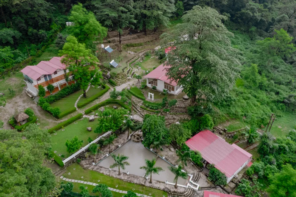The green three-acre Adhiroha ashram campus beside a flowing brook in Upper Tapovan