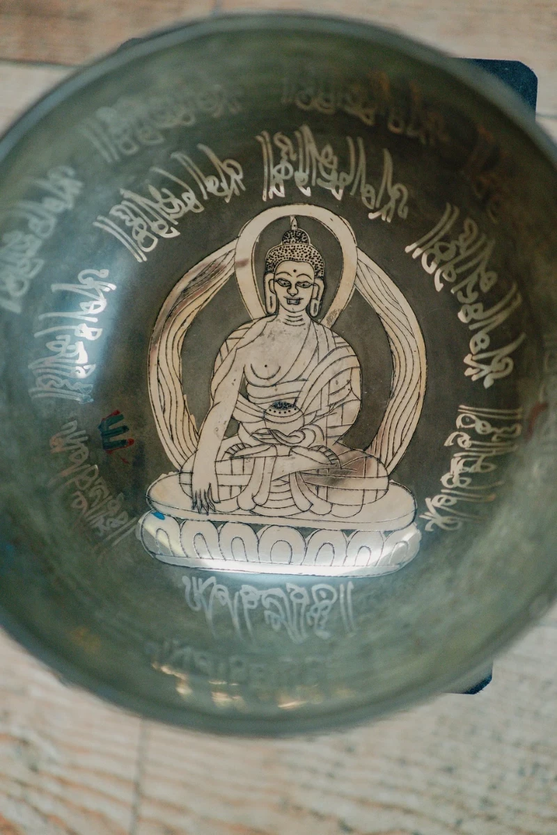 A Tibetan singing bowl inscribed with a sacred figure