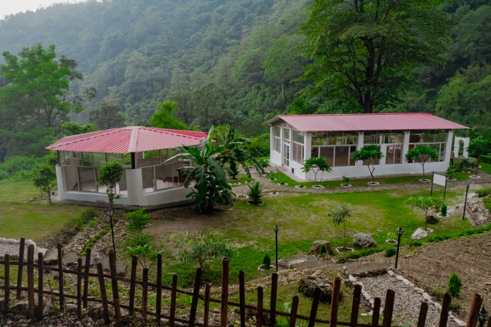 The two shalas of Adhiroha resting on the green hillside