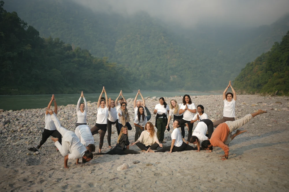 Students practising asana together on the sands of the Ganga Ji ghat