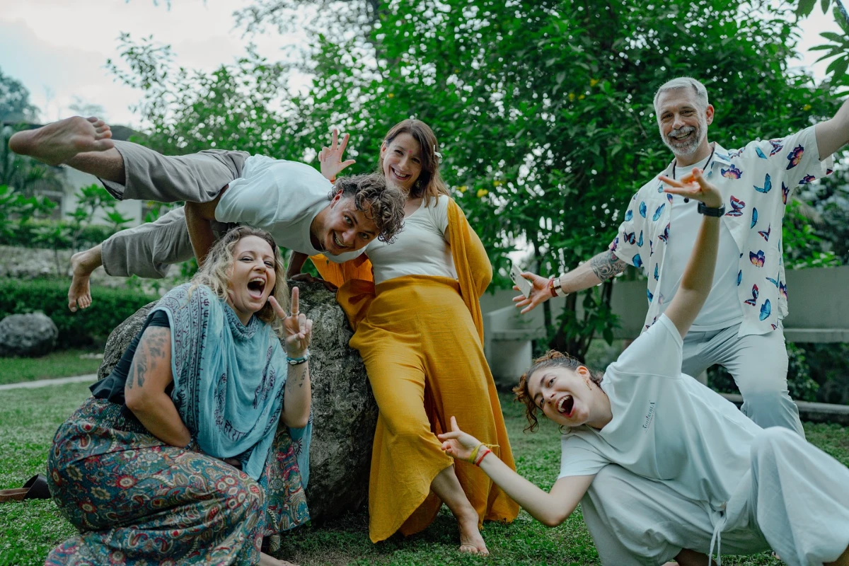 A joyful mixed group of Adhiroha students of all ages in the garden