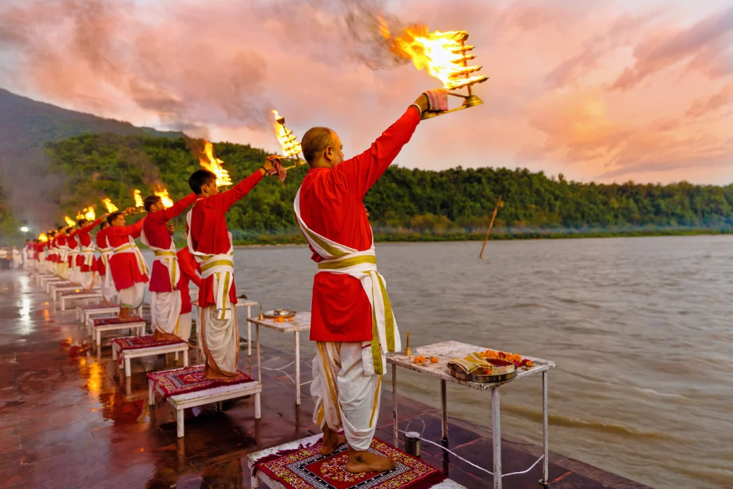 Priests circling great brass lamps at the evening Ganga Ji aarti in Rishikesh